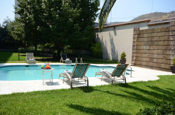 Seasonal outdoor pool, pool loungers
