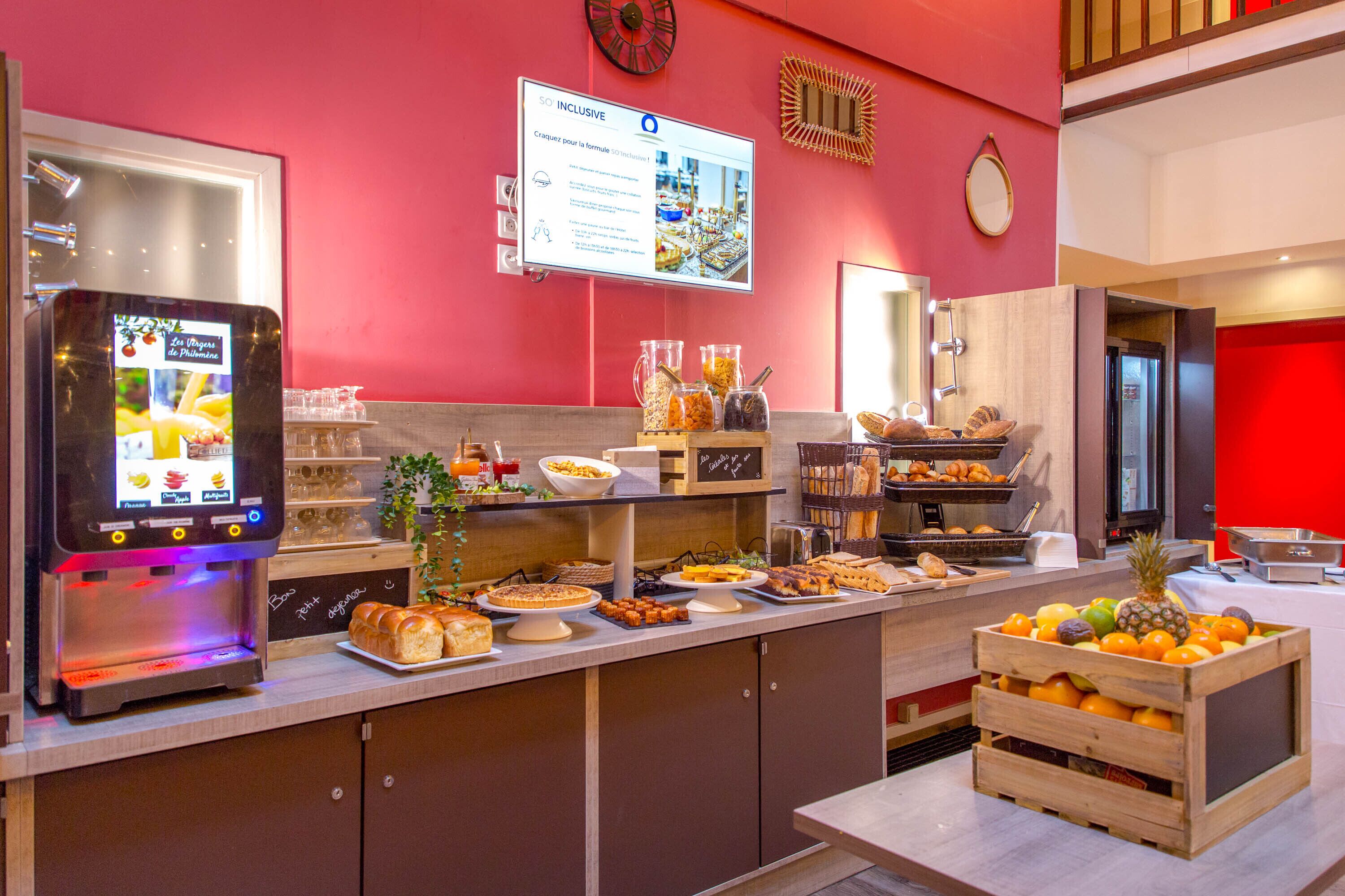 A buffet with various food items and a coffee machine.