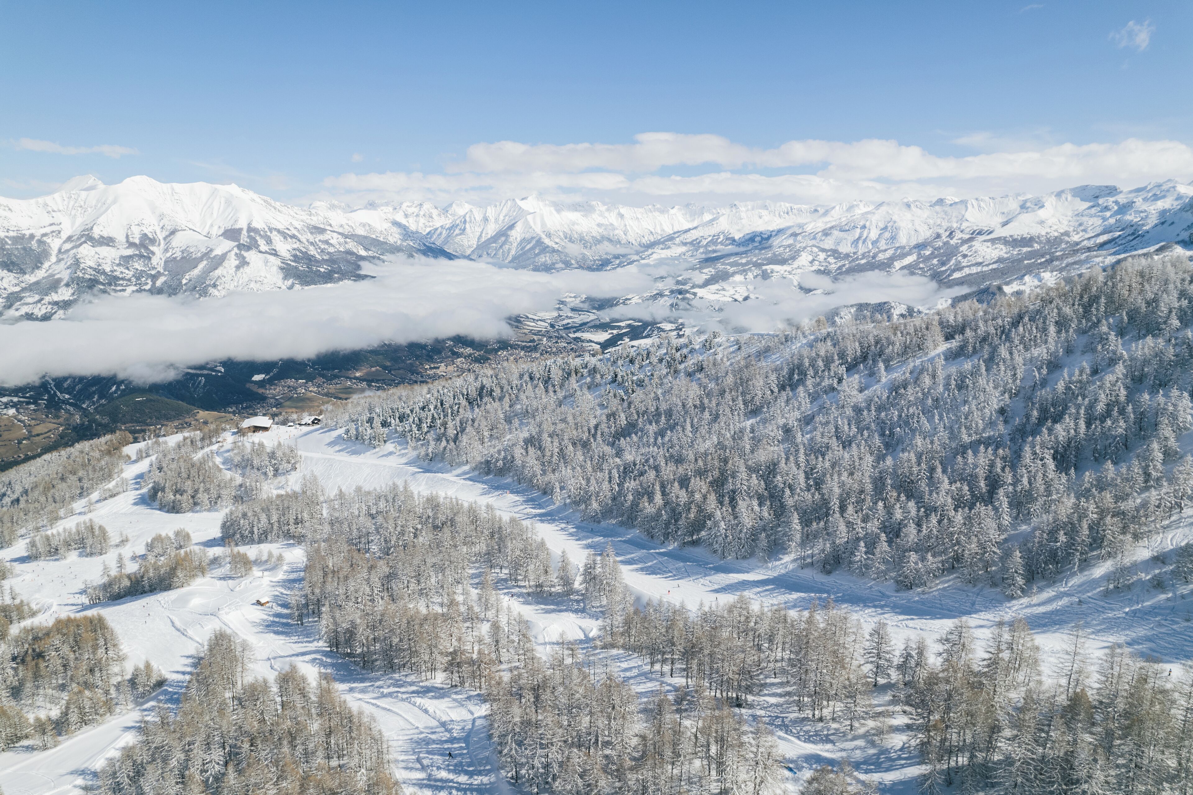 A snow-covered mountain landscape with a ski resort.