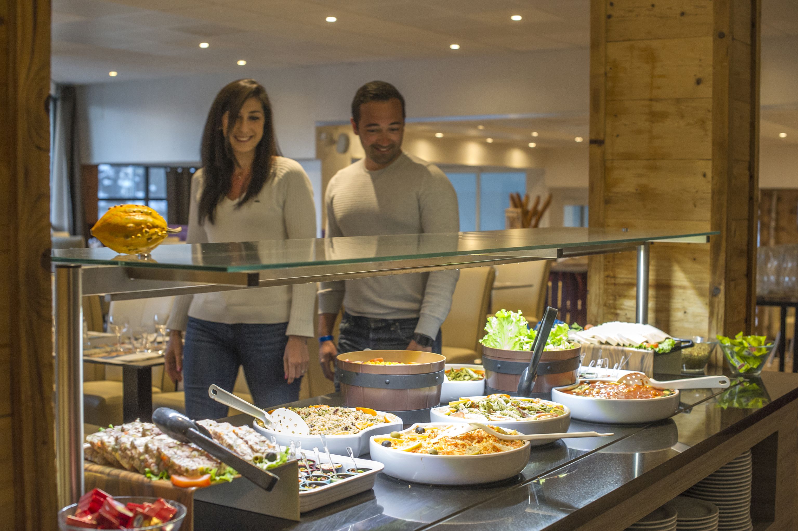 A buffet with various dishes and a glass display case.