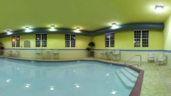 A swimming pool with a tiled deck, multiple windows, and overhead lighting. - Holiday Inn Express Hotel & Suites Magnolia-Lake Columbia by IHG (Magnolia)