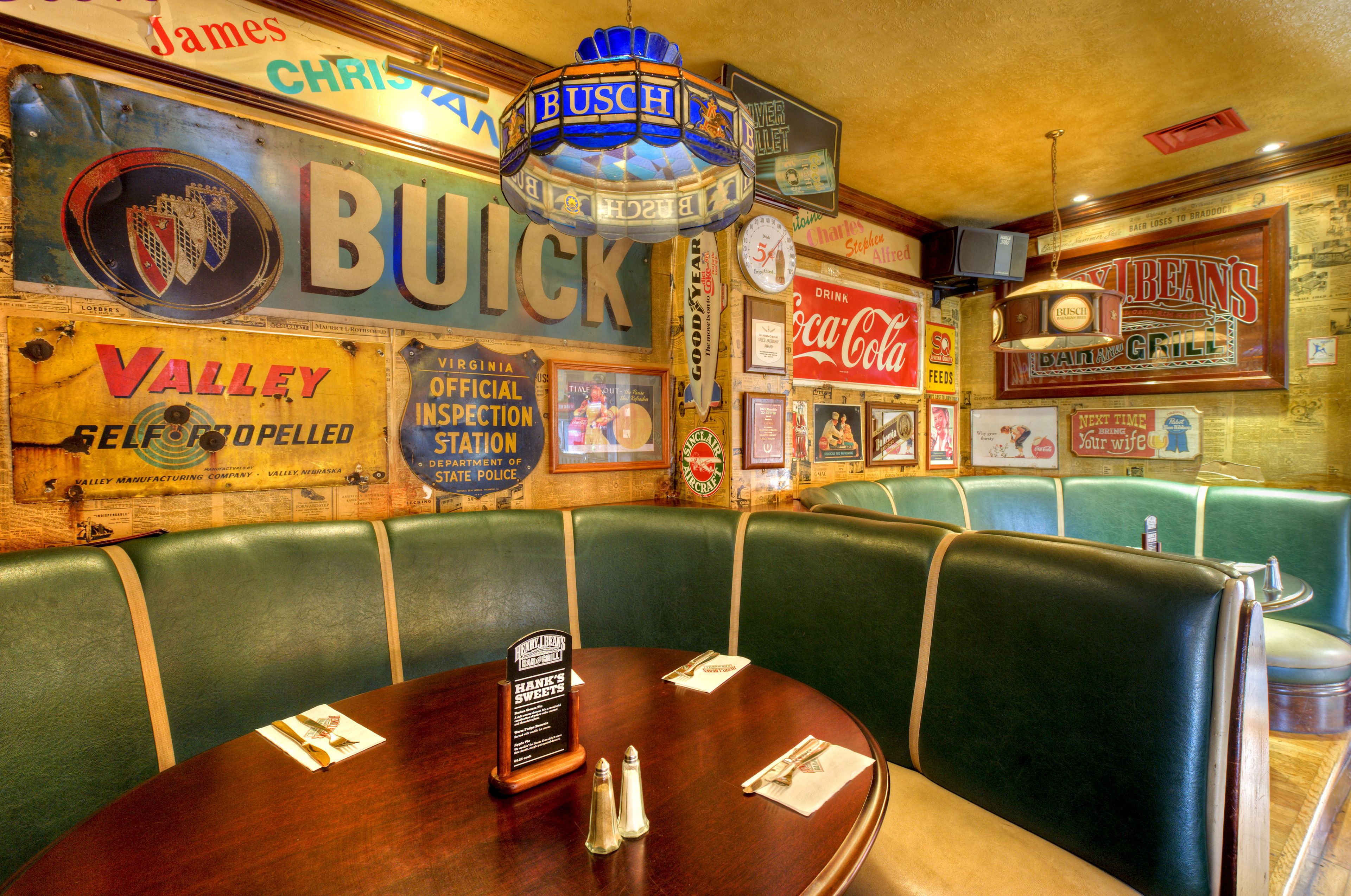 A vintage diner with green booths and a wooden counter.
