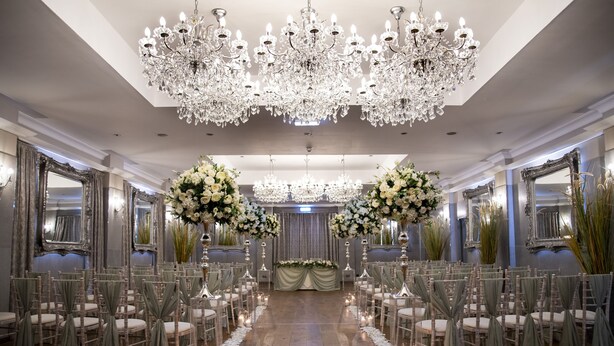 A formal event space with rows of chairs, chandeliers, and floral arrangements. - The Crown Hotel Bawtry, Doncaster (Doncaster)