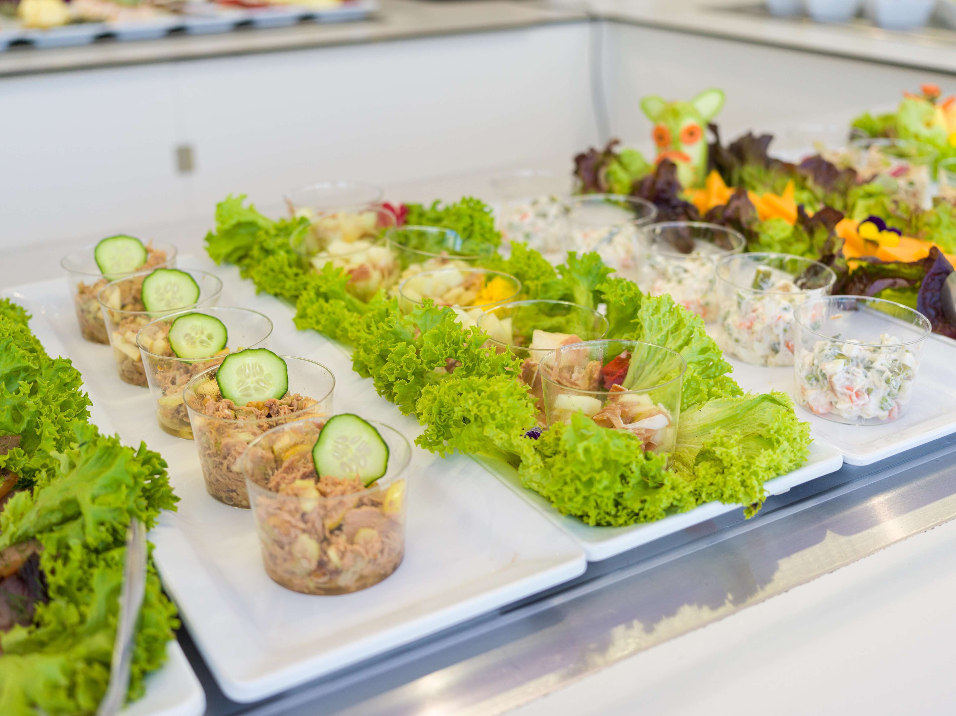 A buffet with various salads and appetizers arranged on a table.