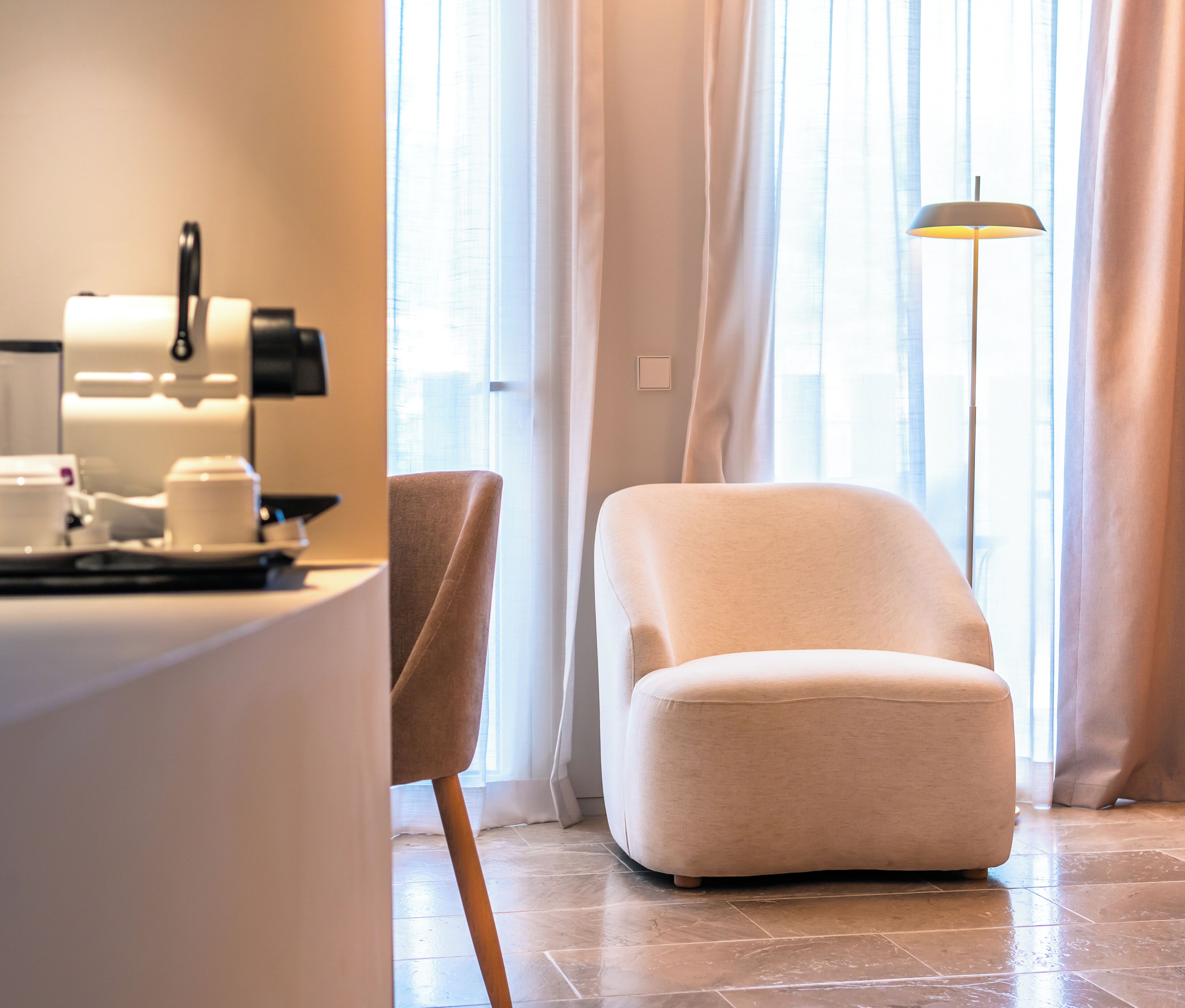 A modern living room with a sofa, a coffee table, and a lamp.