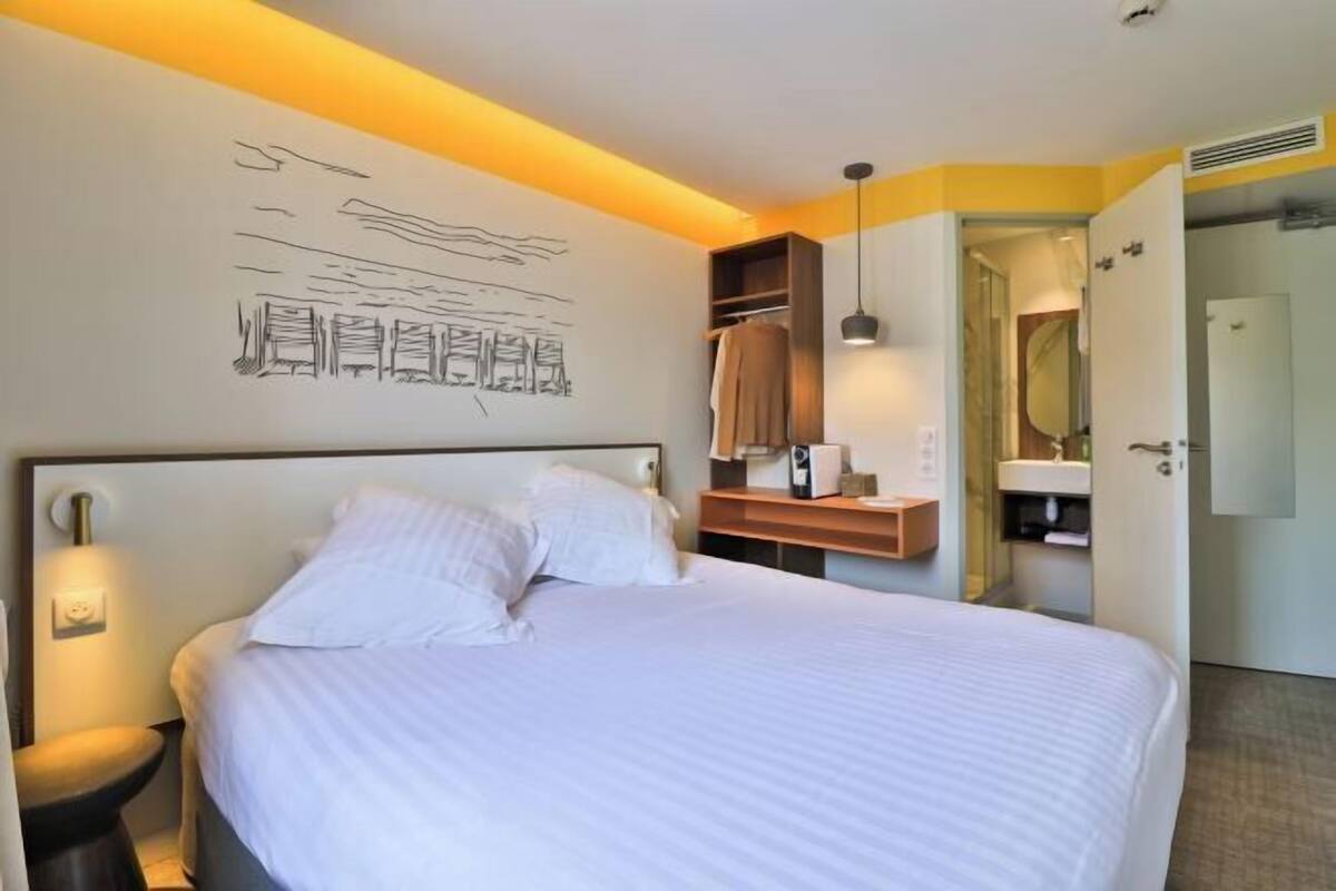 Premium bedding, desk, laptop workspace, blackout drapes