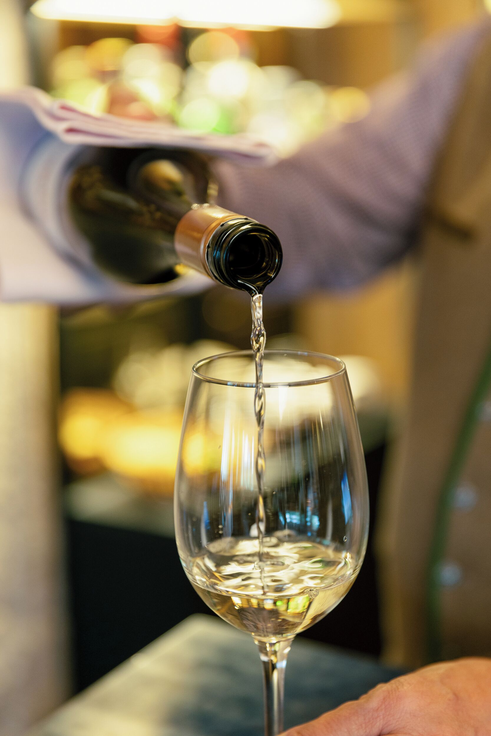 A wine bottle pouring into a glass.
