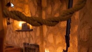 A stone fireplace with a hanging pot and a lit fire. - Lutherhotel Eisenacher Hof - Ringhotel (Eisenach)