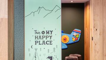 Experience a welcoming atmosphere in this cozy space, featuring a playful illustration and a child-friendly clock.