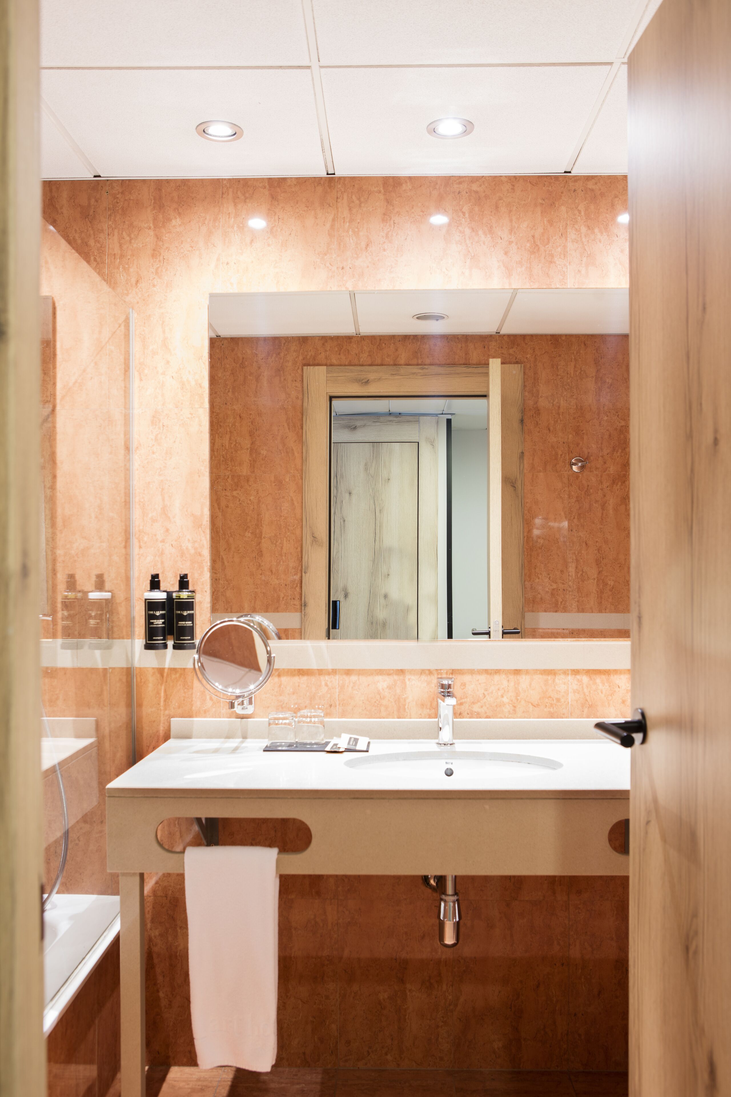 designer toiletries, hair dryer, bidet, towels