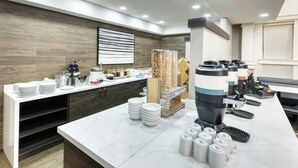A modern breakfast bar with a marble countertop, white plates, and various breakfast items. - Residence Inn by Marriott Whitby (Whitby)