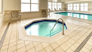 An indoor swimming pool with a hot tub, tiled flooring, and several lounge chairs. - Residence Inn by Marriott Whitby (Whitby)