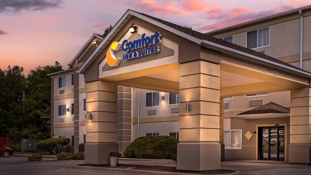 A Comfort Inn & Suites building with a clear entrance, a covered parking area, and a well-maintained landscape.