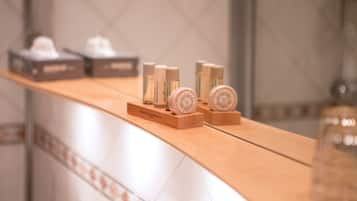 A bathroom counter with toiletries and a mirror.