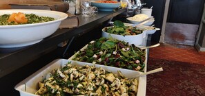 A buffet table with various dishes including salads and a seafood dish. - Eksjo Stadshotell (Eksjo)