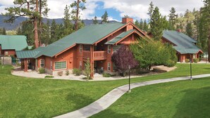 A large, rustic lodge with a green metal roof, multiple windows, and a well-maintained lawn. - WorldMark Big Bear Lake (Big Bear Lake)