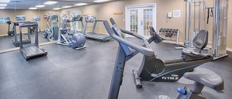 A gym with treadmills, ellipticals, and weight machines.