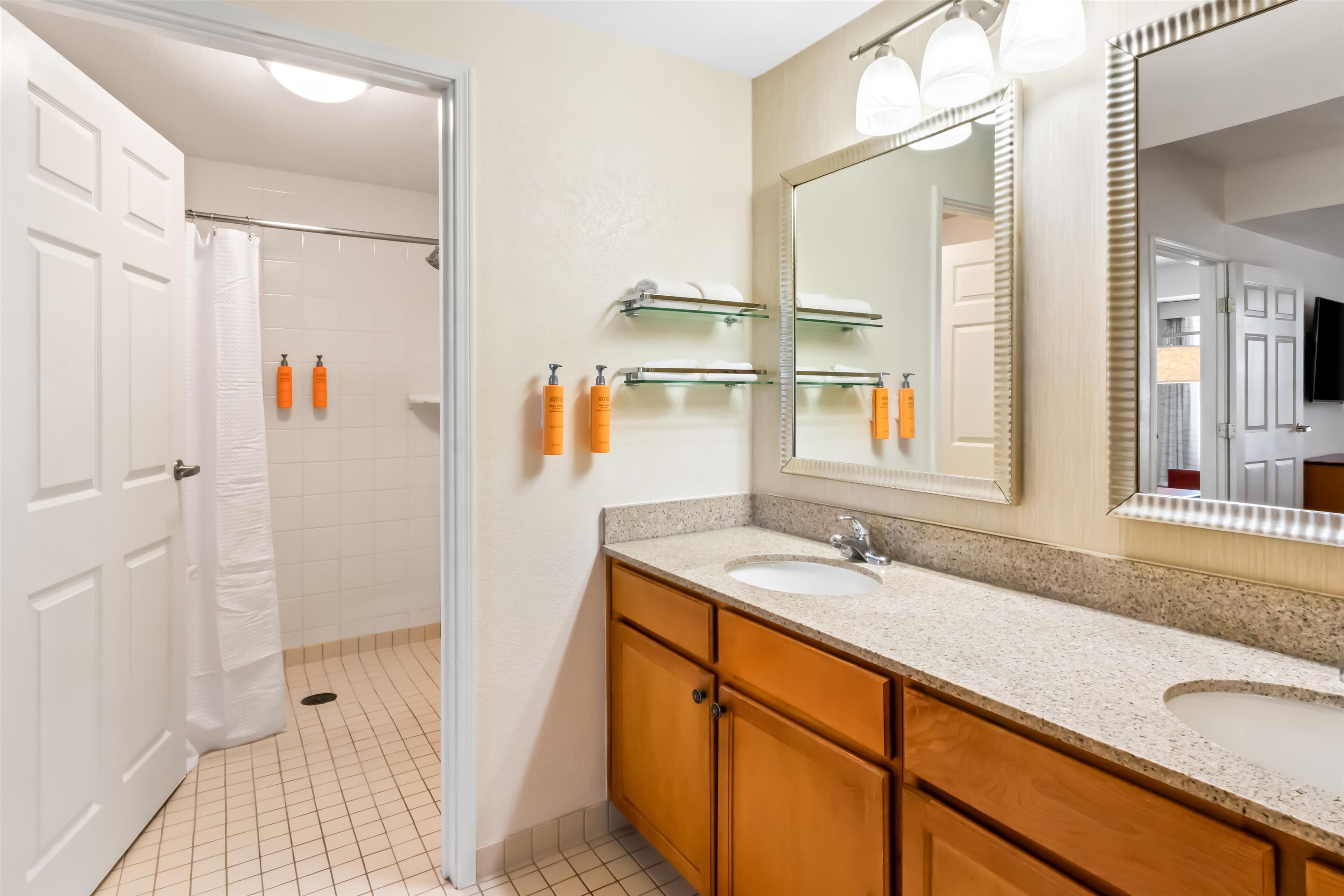 suite, multiple beds, roll-in shower | bathroom | combined shower/bathtub, free toiletries, hair dryer, towels