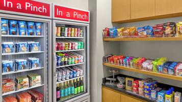 A vending machine stocked with snacks and beverages, including ice cream and sodas.