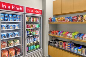 A vending machine stocked with snacks and beverages, including ice cream and sodas. - TownePlace Suites Marriott Joplin (Joplin)