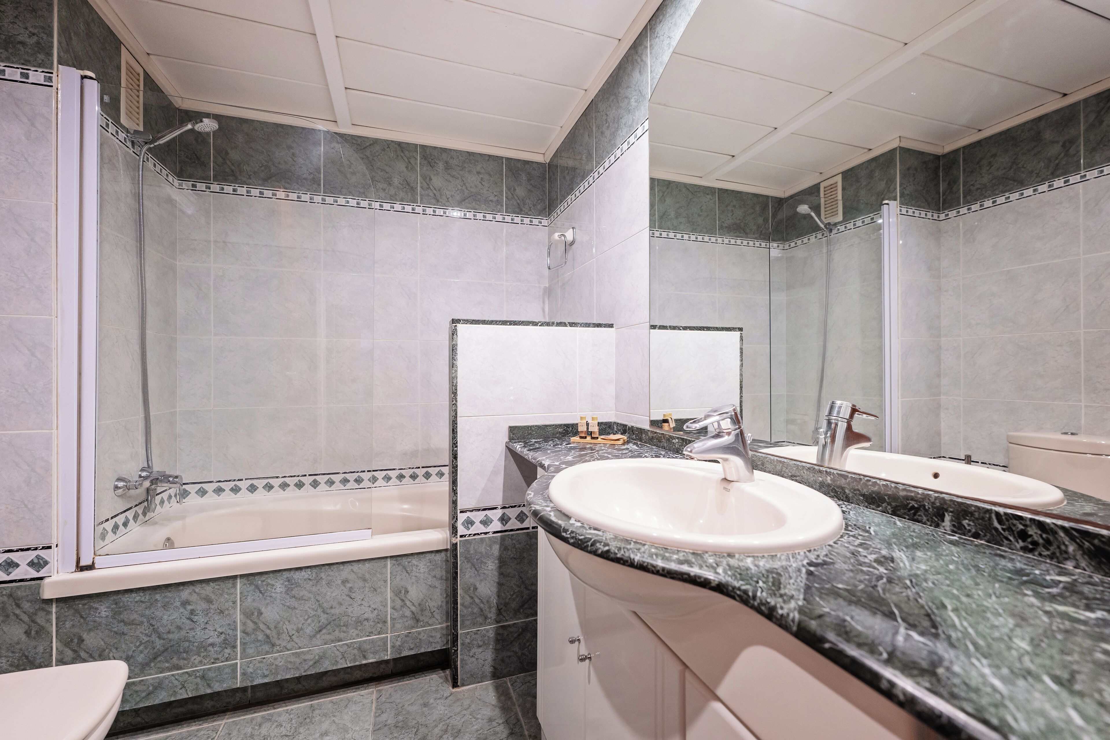 A bathroom with a bathtub, a sink, and a shower.
