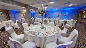 A banquet hall with round tables, white chairs, and blue lighting. - Best Western Premier Suites Hotel & Spa Liverpool-Knowsley (Liverpool)