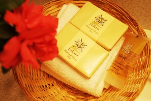 A wicker basket containing Proterra® Milk and Honey Bar soap and a shampoo bottle.