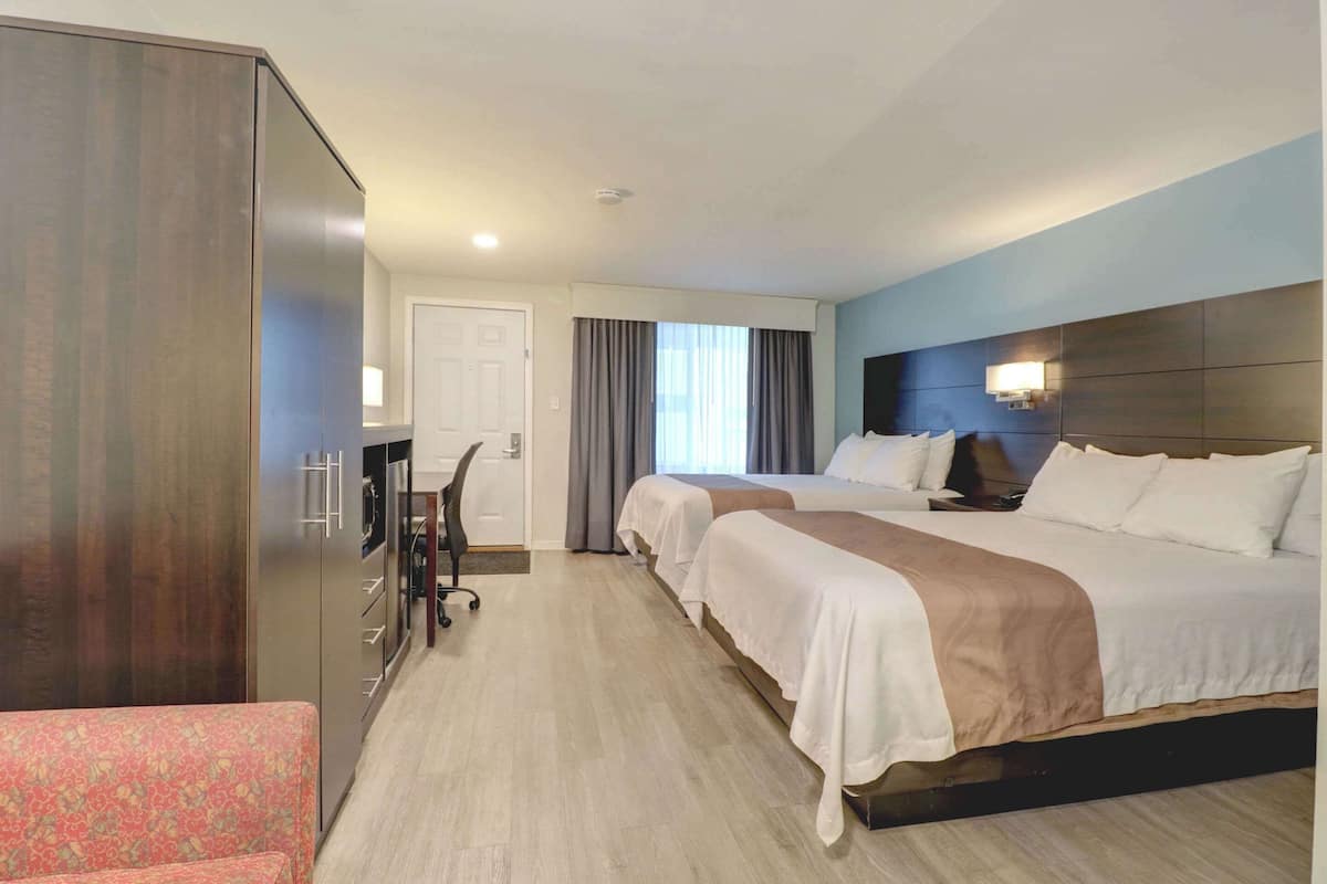 Premium bedding, desk, laptop workspace, blackout drapes