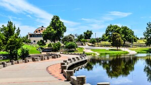 A park with a pond, pathways, and a building with a dome. - Fairfield Inn & Suites by Marriott San Angelo (San Angelo)