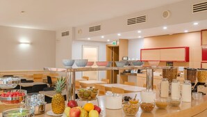 Un buffet de petit-déjeuner proposant une variété de fruits, de céréales et de boissons.