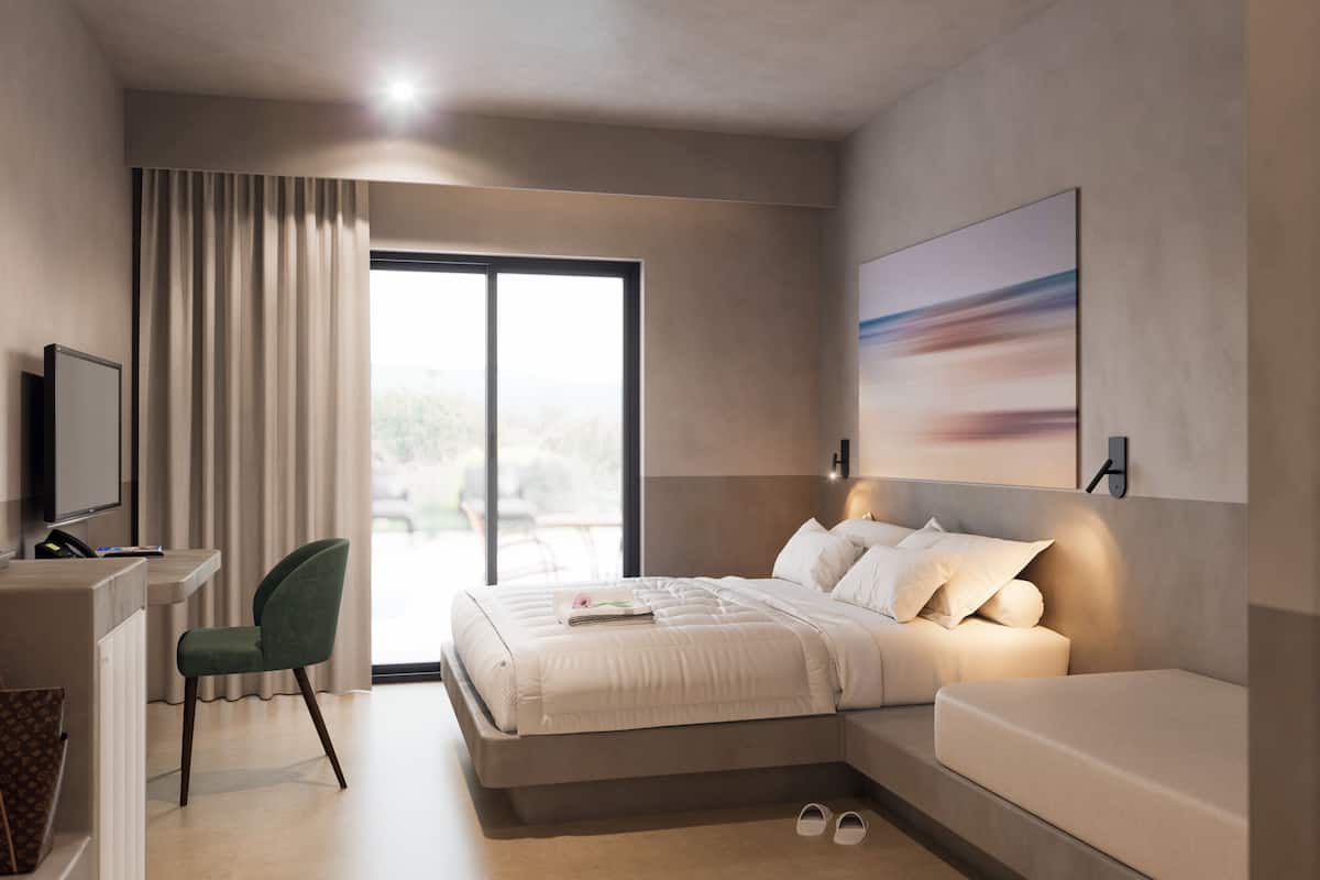 A modern hotel room with a bed, a desk, and a chair.