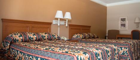 A hotel room with a large bed, two bedside tables, a chair, and a lamp.