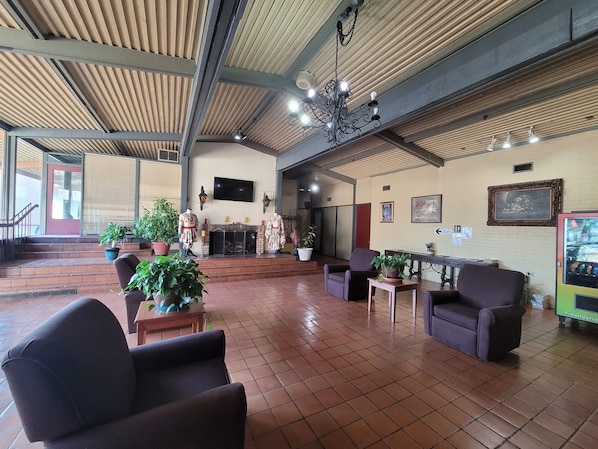 A spacious lobby with a fireplace, seating area, and a vending machine. - Stay Express Inn Athens (Athens)
