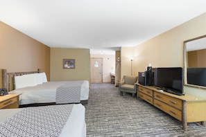 A hotel room with two beds, a desk, a chair, a television, and a mirror. - The Lodge at Crooked Lake (Siren)