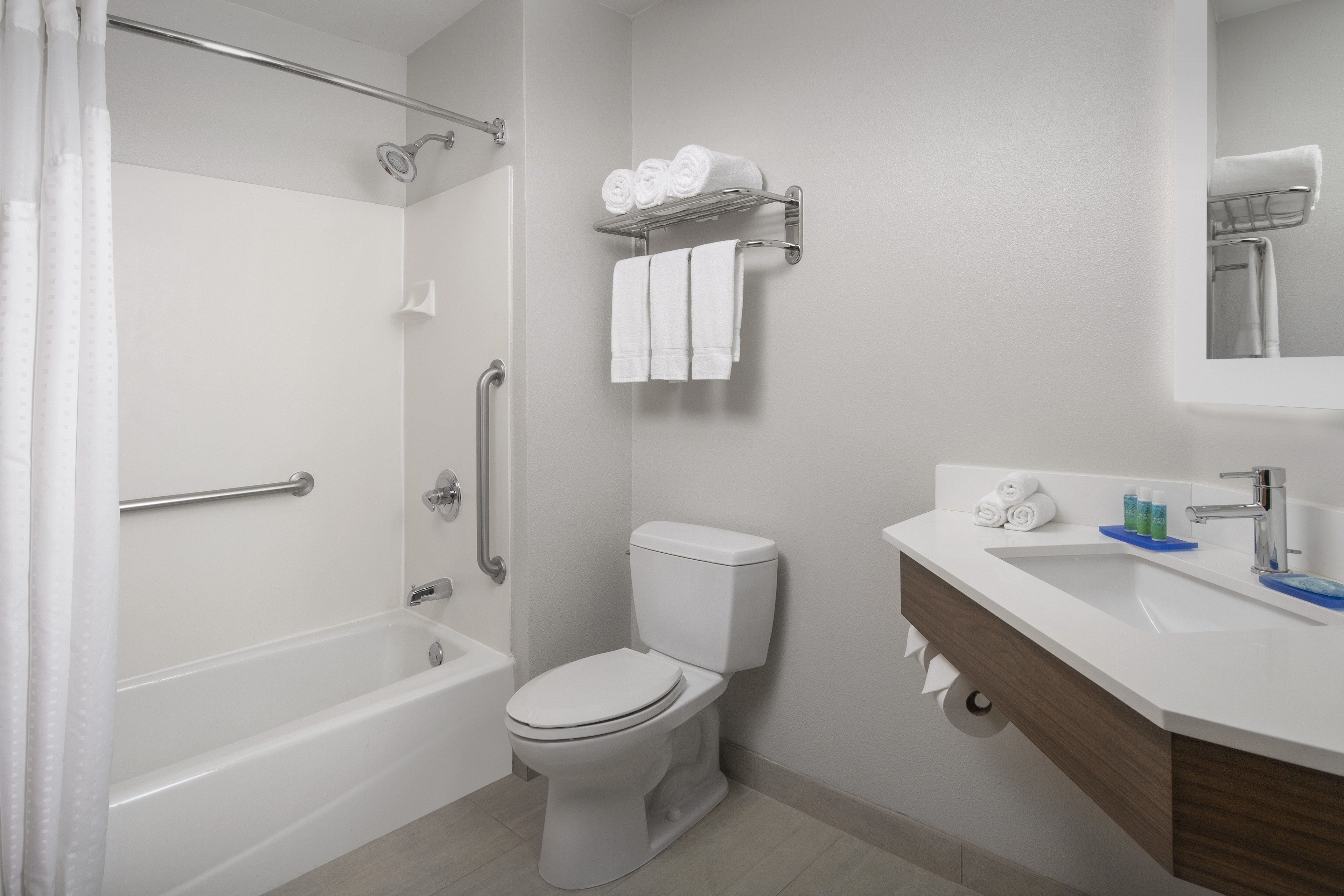 A bathroom with a bathtub, toilet, and sink.