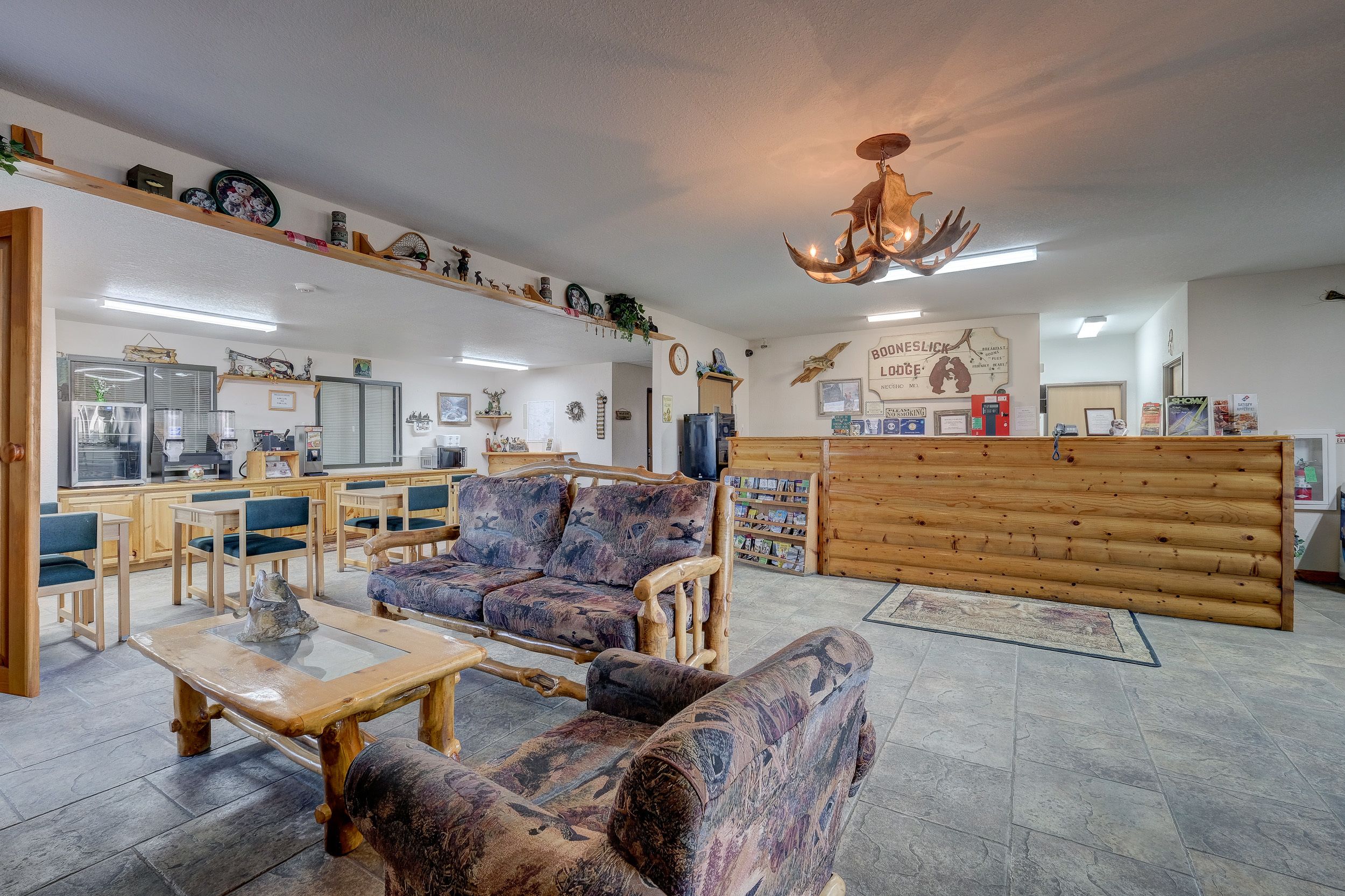 A cozy interior with wooden furniture, a reception desk, and various wall decorations.