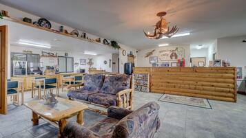 A cozy interior with wooden furniture, a reception desk, and various wall decorations.