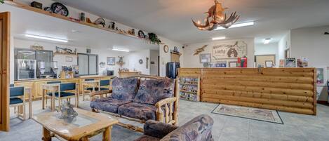 A cozy interior with wooden furniture, a reception desk, and various wall decorations.