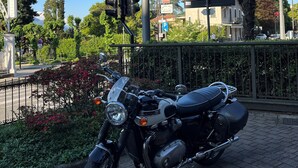 A motorcycle parked in front of a sign that reads "Hotel della Torre." - Hotel Della Torre (Stresa)