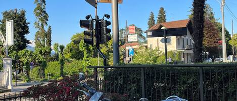 A motorcycle parked in front of a sign that reads "Hotel della Torre."