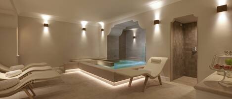 Et moderne spa-rum med et stort badekar, liggestole og et glasindrammet bruseområde.
