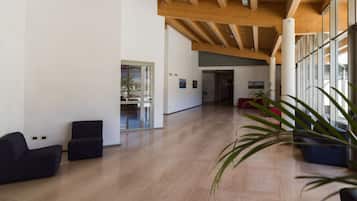 Relax in a spacious room with high ceilings, polished floors, and large windows.