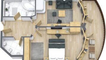 Distribución de una habitación de hotel que incluye baño, zona de estar con sofá y mesa de comedor, y un dormitorio independiente con cama.