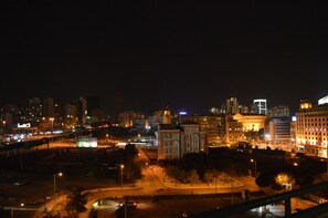 A nighttime cityscape with illuminated buildings and a clear view of the urban layout. - Markazia Suites (Beirut)