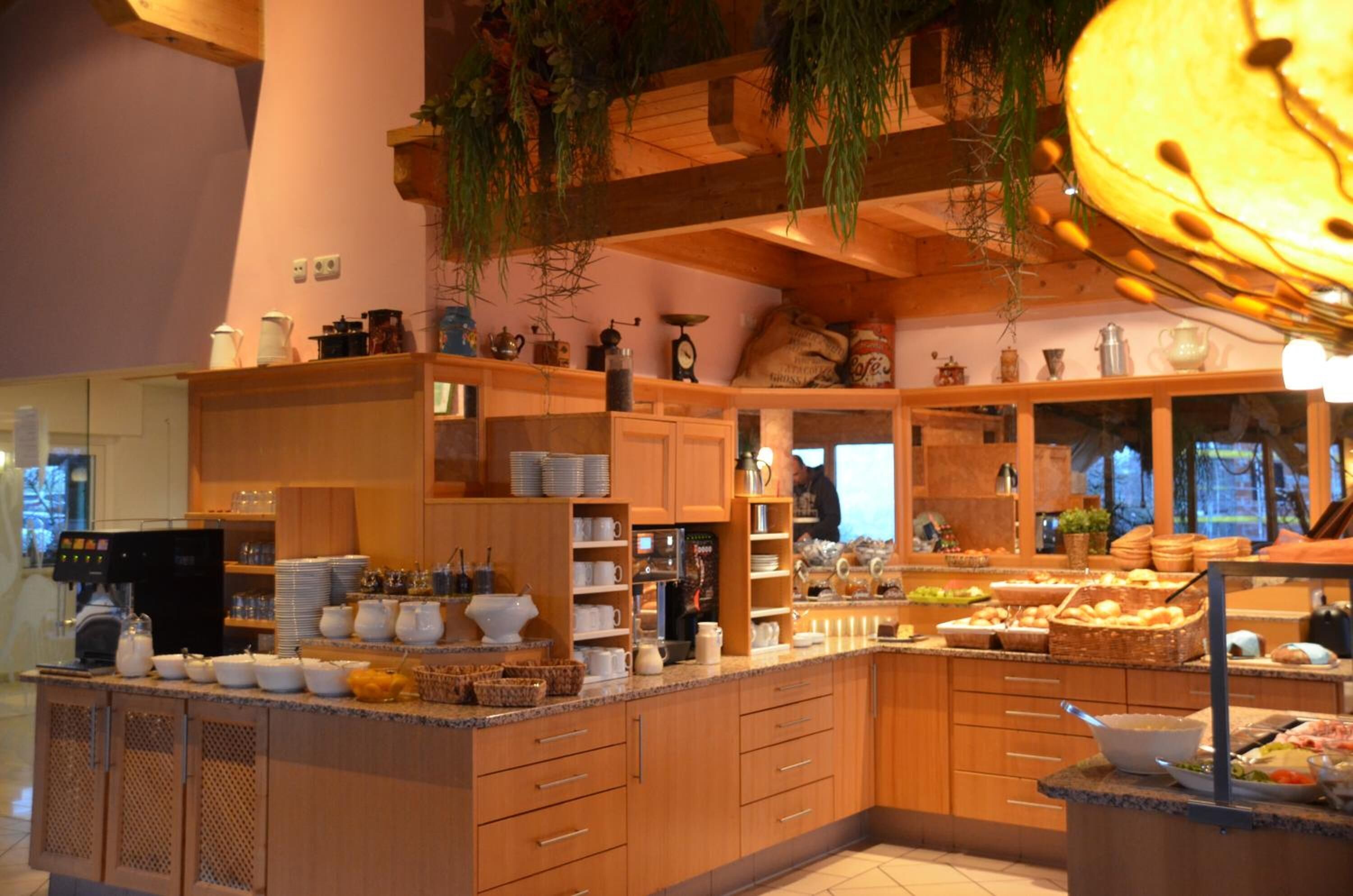 A kitchen with wooden cabinets, a coffee machine, and various kitchen utensils.