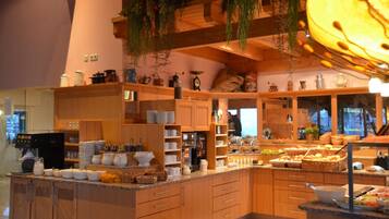 A kitchen with wooden cabinets, a coffee machine, and various kitchen utensils.