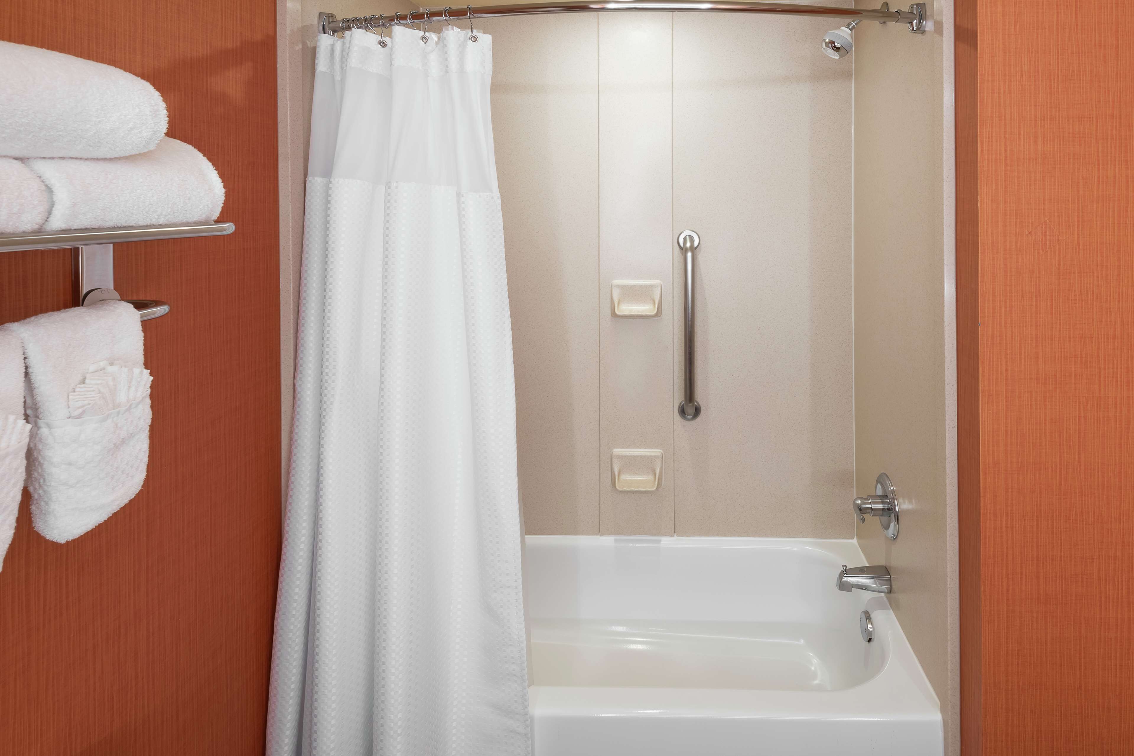 combined shower/bathtub, designer toiletries, hair dryer, towels