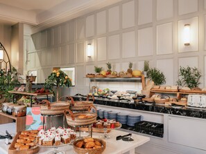 Montaje tipo bufé con diversos alimentos, cestas y utensilios de cocina.