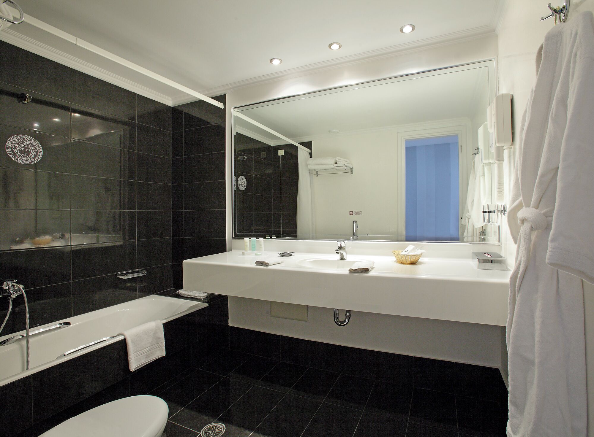 bathtub, designer toiletries, hair dryer, bathrobes