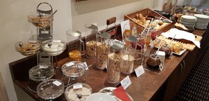 A buffet with various food items and condiments. - Hotel Königer (Pliening)
